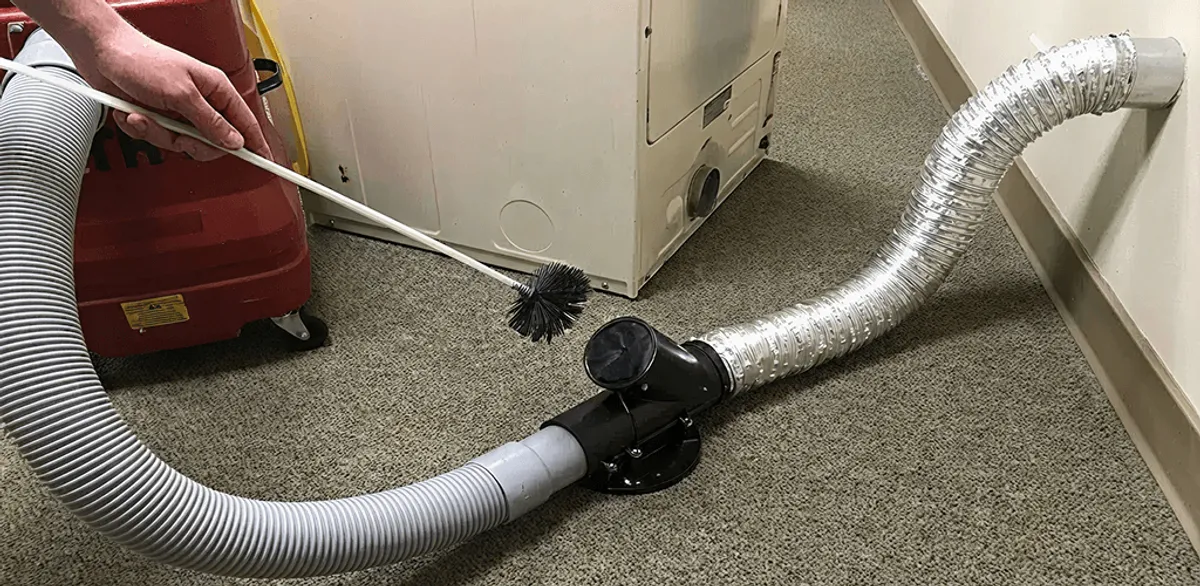 Dryer vent cleaning service removing lint from a dryer duct connection in Las Vegas, NV