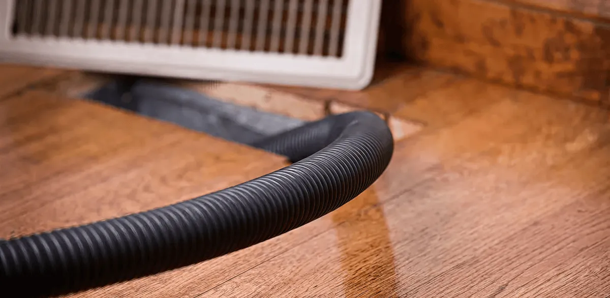 Air duct cleaning hose inserted into a floor vent for ductwork cleaning in Las Vegas, NV