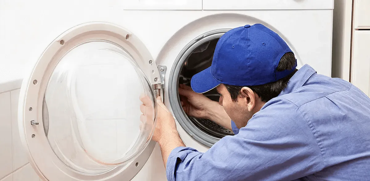 Washing machine repair handyman inspecting a front-load washer drum in Las Vegas, NV