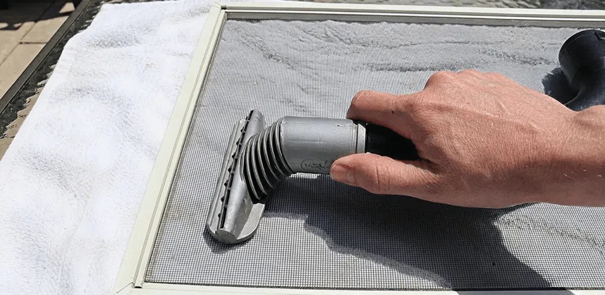 Window screen repair cleaning and fixing a damaged screen mesh in Las Vegas, NV